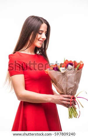 image of cute woman in red dress with bouquet of tulips