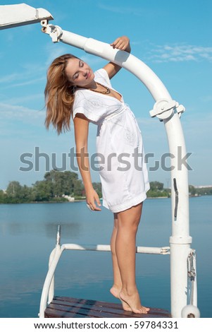 woman in white dress enjoys on the yacht
