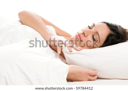Beautiful young woman sleeping on white isolated