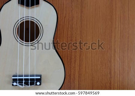 ukulele guitar on wood background