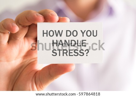 Closeup on businessman holding a card with HOW DO YOU HANDLE STRESS ? message, business concept image with soft focus background