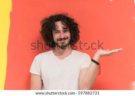 Portrait of a beautiful  young man with funny hair over color background with copyspace expressing different emotions