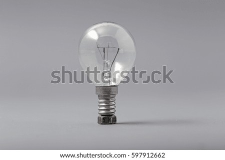 Electric light bulb on a gray background.
