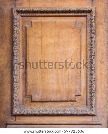 Element of a wooden door with a carved frame. Backgrounds and textures