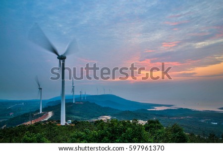 Windmills for electric power production.the wind farm under the glow of dawn, slow the rotation of the fan dynamic picture shooting. Located in the mountains of Poyang, china.