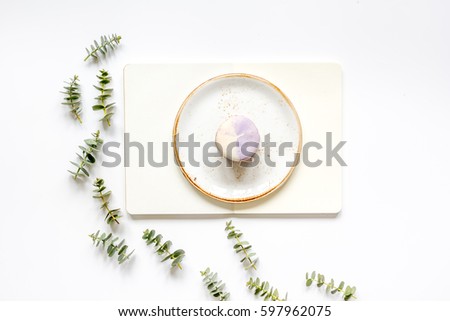 woman table in pastel color with notebook, macaroons on plate and eucalyptus on white background top view mock-up