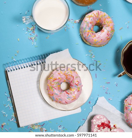 The ideal breakfast for the proper energy for the full day. Fresh coffee with milks and donuts . Hipster pictures. Top view