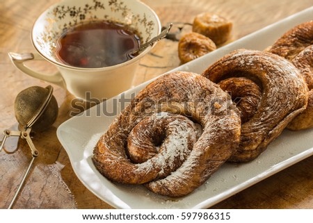 Teaparty with zeeuwse bolus on the whitw plate and table of wooden background. Royalty-Free Stock Photo #597986315