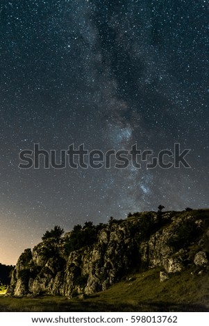 Milky Way over the stone at Cheile Dobrogei. Long time exposure night landscape with Milky Way Galaxy 
