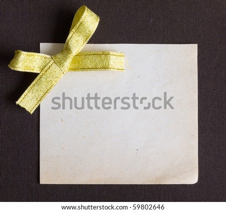 blank paper note with golden bow