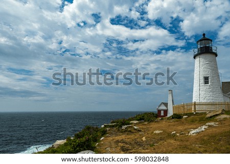 The Pemaquid Point Light is an historic lighthouse in Bristol, Maine, at the tip of the Pemaquid Neck. The lighthouse was commissioned in 1827 by President John Quincy Adams and built that year. Royalty-Free Stock Photo #598032848