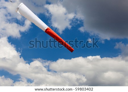 windsock in a  sky with clouds
