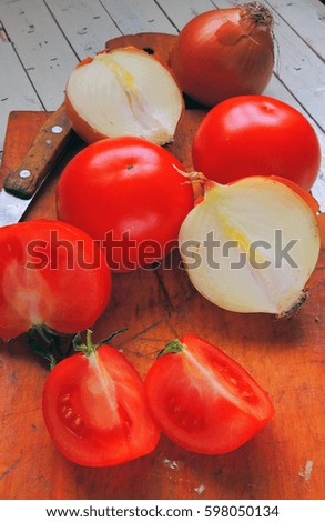 Fresh vegetables Tomato and onions on a wooden Board