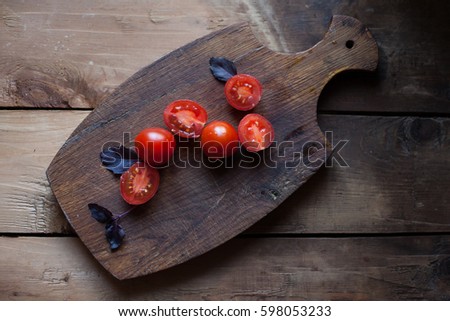cherry tomatoes, basil, wood background
