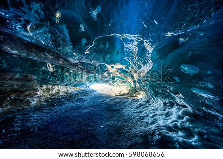 Blue ice cave in Vatnajokull glacier, Iceland  Royalty-Free Stock Photo #598068656
