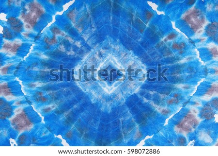 textile background - abstract blue geometric ornament hand painted in nodular technique on silk batik