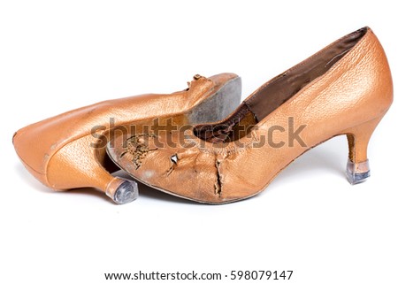 closeup shot of pair of worn-out latin ballroom dance shoe - isolated