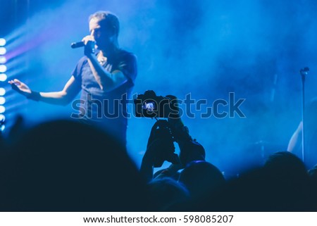 Woman takes pictures at a concert