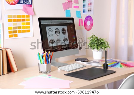 Modern designer workplace with computer and stationery
