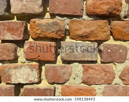 Brickwall Getting Older. Red bricks built wall. You can see cement, grout between bricks. Great for wallpaper, pattern.