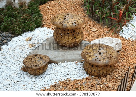 Artificial mushrooms made from stone on pile of rocks background.