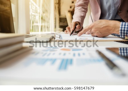 Sales team discussion process.Business crew working with new startup project.Notebook,tablet wood table, using devices.Creative Idea presentation.Analyze market stock.Blurred background,film effect.