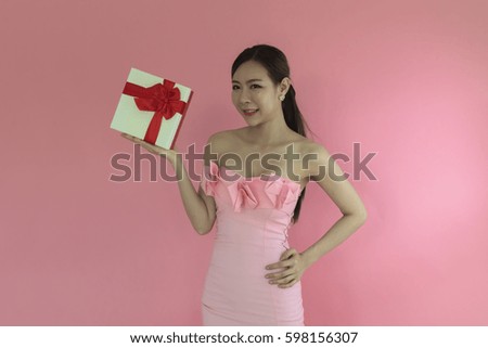 Woman Pink dress gets a gift box.