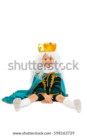 The little prince sits on the floor. White background.