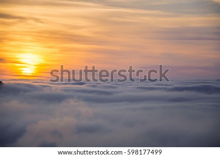 Beautiful sunrise above the fog
