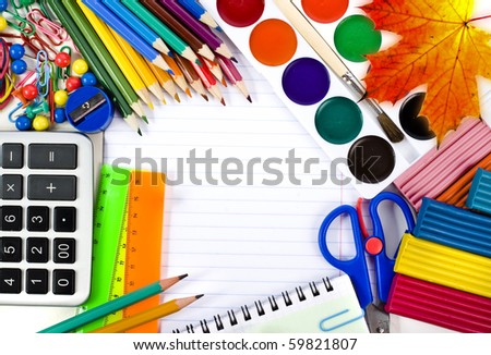 Notebook , colored pencils, back to school concept surface  with copy space over white background 