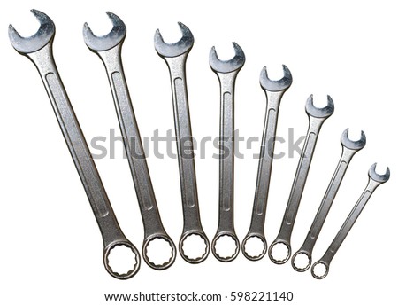 Spanner Set Arc Isolated. Silver coloured spanners lying side by side in white background. Royalty-Free Stock Photo #598221140