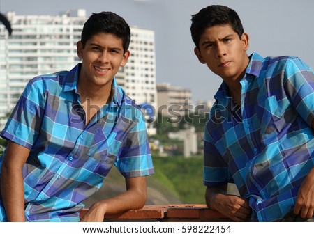 Teen Boy Posing As Twin Brothers Royalty-Free Stock Photo #598222454