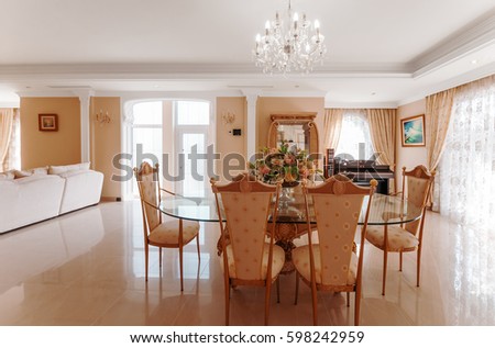 A luxurious interior with a dining area and marble floor.