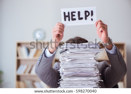 Businessman busy with paperwork in office Royalty-Free Stock Photo #598270040