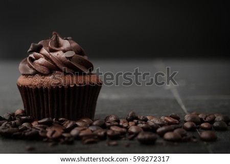 Chocolate cupcakes with coffee beans on dark background, AF point selection.