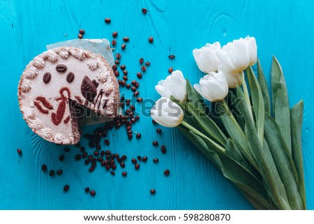 cake, tulips and coffee on blue background