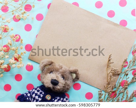 teddy bear decorate with dried flower and alarm clock on space copy background