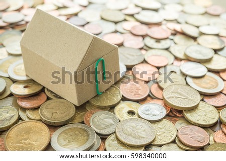 Recycle paper house on heap of vary country coins background - ideas house real estate concept