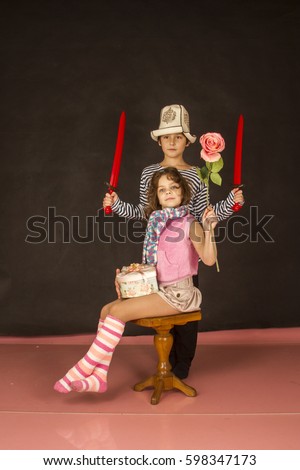 Boy in vest and girl with flower
