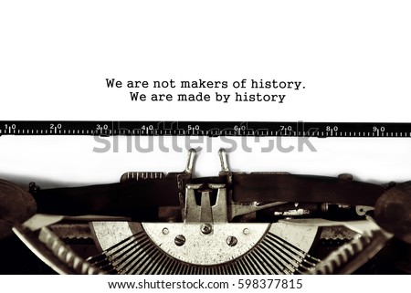 Vintage typewriter on white background with text We are not makers of history. We are made by history 