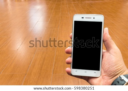 cellular telephone in Wooden floor Brown background