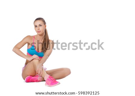 A young slender woman is engaged in fitness. Isolated white background