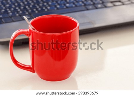 Red coffee cup on office desk