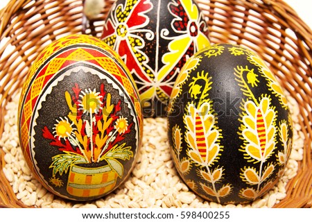 Couple Easter eggs in a basket. Pisanka - traditional art.