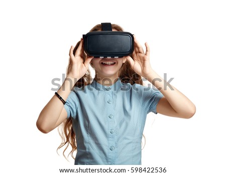 Young girl with virtual reality glasses.  Isolated on white background.  VR headset. Royalty-Free Stock Photo #598422536