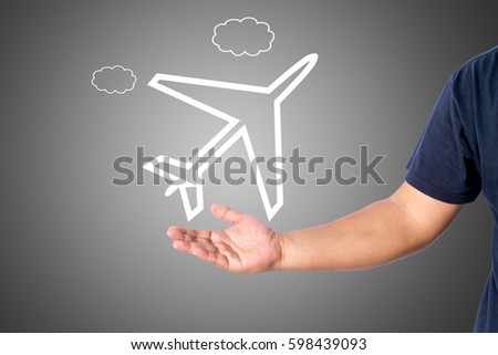 A man in casual wear holding a flight travel logo isolated over gray background with copy space for add word text title.