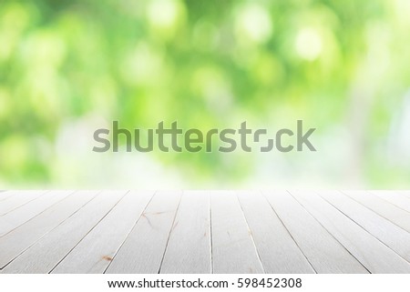 Empty wooden table with blurred city park on background. concept party, products, spring.