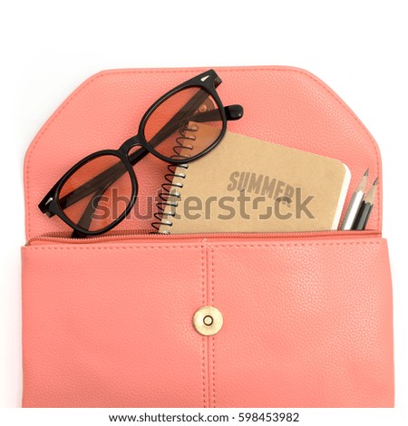 Notebook sunglasses and pensils in pink leather bag