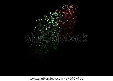 Freeze motion of color powder coming down on black background,Abstract design of falling dust cloud,artificial snow fall concept.