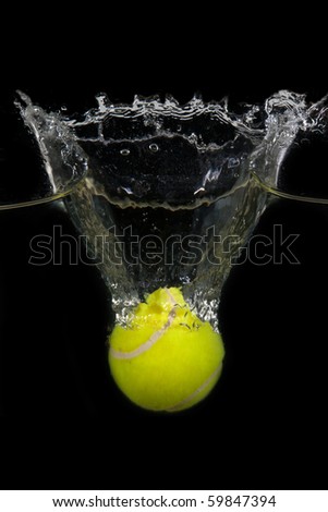 A tennis ball  is dropped into water in front of black background Royalty-Free Stock Photo #59847394